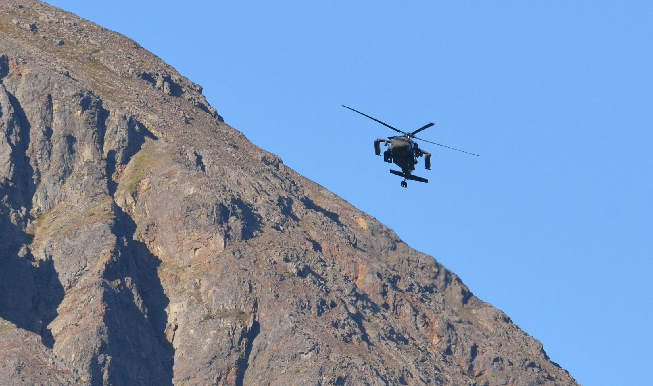 A Blackhawk helicopter monitored Exit Glacier Road, where onlookers eagerly awaited the presidential motorcade.